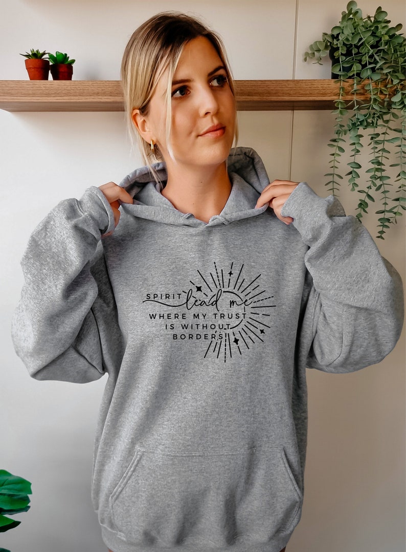 May include: A gray hooded sweatshirt with a black graphic print that reads "Spirit lead me where my trust is without borders".