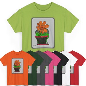 May include: A selection of short-sleeved t-shirts in colours such as green, orange, and red. Each shirt displays a graphic of a cactus with an orange flower in a black pot, framed within a grey rectangle.