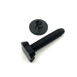 May include: A black plastic bolt with a wide, flat, T-shaped head and a threaded shaft, accompanied by a separate, circular, black plastic washer featuring a central hole and a slotted, recessed design on its top surface.