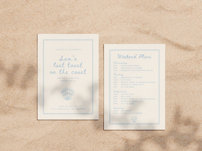 May include: Two cream-colored cards with light blue text and borders. The left card reads "Sam's last toast on the coast" with a seashell graphic. The right card lists weekend plans. The cards are on a sandy surface.