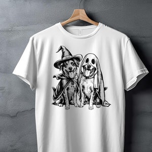 White shirt with graphic of dogs wearing witch and ghost costumes.