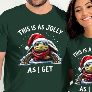 May include: Two green t-shirts with a Christmas turtle wearing a Santa hat and the text "This is as jolly as I get".