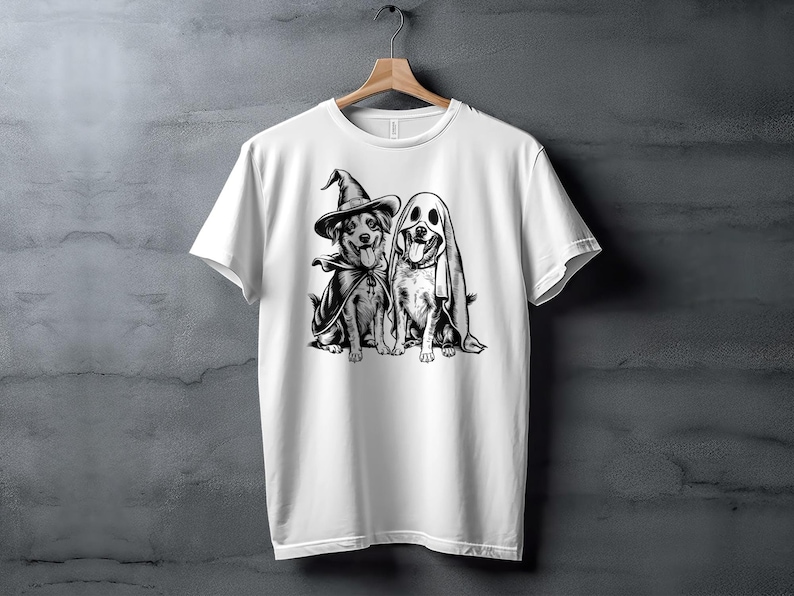 White shirt with graphic of dogs wearing witch and ghost costumes.