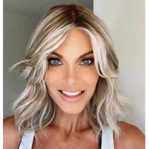 Carli cute luxe synthetic, dimensional blonde mid length wavy curtain bang, full monofilament lace cap and lace front undetectable hairline!