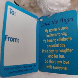 May include: A blue and yellow card with the text "Love the Angel" and a poem about love and celebration. The card has blank spaces for "To:" and "From:" and a website address at the bottom.