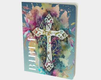 May include: A notebook cover with a watercolor background featuring a white cross with ornate details. The cross is surrounded by colorful floral designs and the word "BIBLE" is written vertically on the left side of the cover.