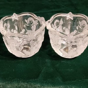 A Pair of Mikasa Votive Candle Holders that are Clear and Frosted with Angels