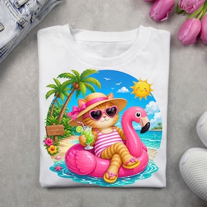 Puede incluir: Camiseta blanca con un gato de dibujos animados relajándose en un flotador de flamenco rosa. El gato lleva gafas de sol en forma de corazón, un sombrero de paja y un traje de baño a rayas. El fondo incluye palmeras, un cielo soleado y una escena de playa.
