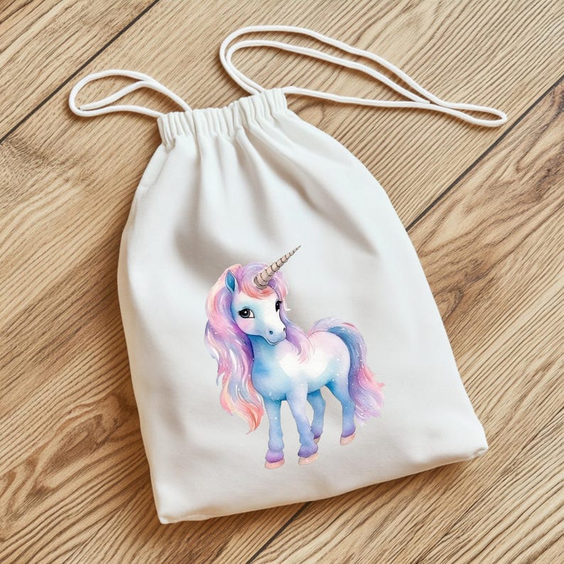 May include: White drawstring bag featuring a watercolor unicorn illustration. The unicorn has a blue body, pink and purple mane and tail, and a silver horn. The bag has a white drawstring closure.