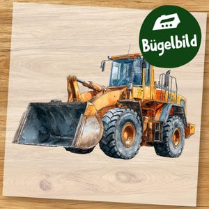May include: Watercolor illustration of a yellow front-end loader with a large bucket. The construction vehicle has large black tires and is set against a light wood grain background. A green circle with the text "Bügelbild" is in the upper right corner.