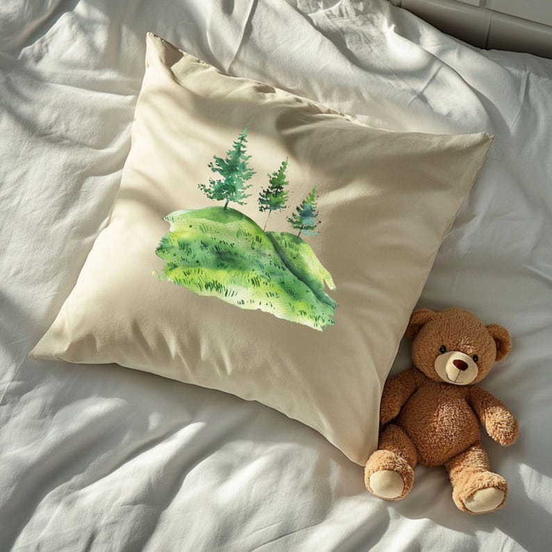 May include: A beige pillowcase featuring a watercolour painting of three green trees on a green hill. The pillowcase is on a white bed with a brown teddy bear.