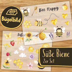 Pode incluir: Desenhos de transferência a quente com abelhas, favos de mel, girassóis e a frase "Bee Happy". Os desenhos incluem ilustrações em aquarela de abelhas, corações e outros elementos com tema de abelhas. Em um fundo de madeira.