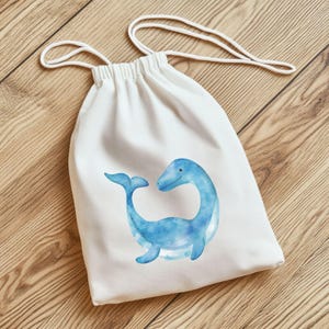 May include: A white drawstring bag featuring a watercolor illustration of a friendly blue sea creature. The bag has a simple design with a white drawstring closure. The sea creature is depicted with a long neck and tail, and a smiling face.