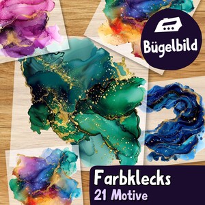 May include: A selection of iron-on transfer designs with abstract watercolour art in blue, green, purple, and gold. The designs are displayed on a wooden surface. The image includes text that reads "Farbfleck" and "21 Motive".