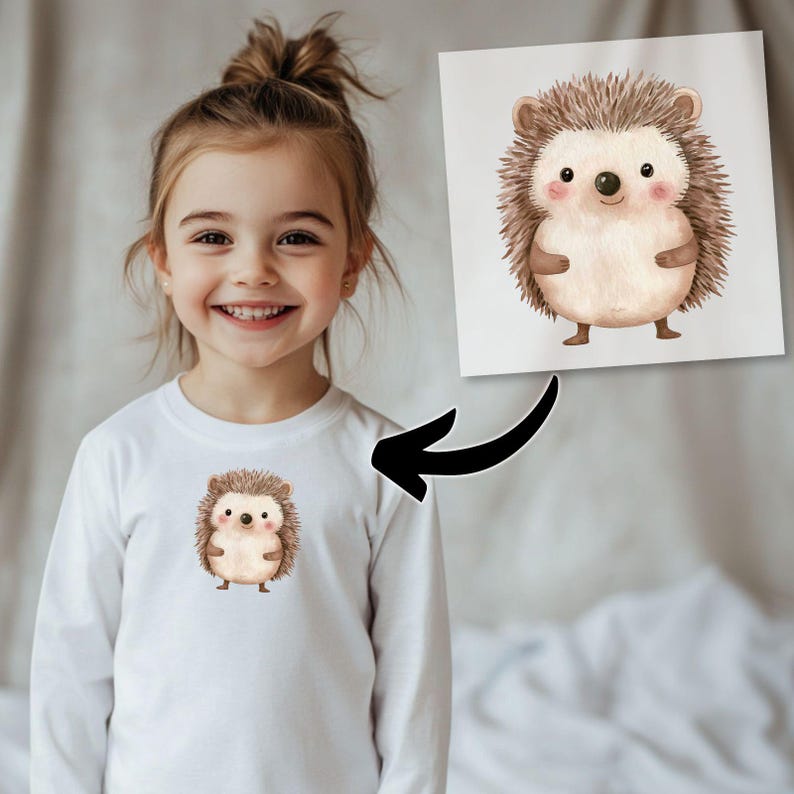 May include: A white long-sleeved shirt featuring a cute cartoon hedgehog design. The hedgehog is brown with a light brown tummy and has a friendly expression.