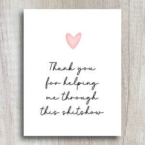 May include: A white card with a pink heart and the text "Thank you for helping me through this shitshow."