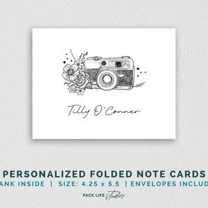 May include: A black and white illustration of a camera with flowers on a white folded note card. The card has the text "Tilly O'Conner" and the text "PERSONALIZED FOLDED NOTE CARDS BLANK INSIDE | SIZE: 4.25 x 5.5 | ENVELOPES INCLUDED PACK LIFE Studios".
