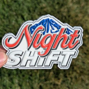 May include: White patch with black stitching, featuring a red and white "Night Shift" logo with a blue mountain graphic.