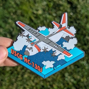 May include: A white and gray USCG HC-130J aircraft flying through clouds. The aircraft has red and orange accents. The image is a 3D design with a blue and black background.