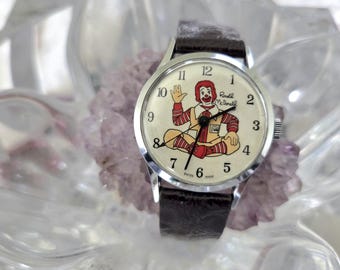 Reloj mecánico suizo de cuerda manual de Ronald McDonald, estilo años 70.
