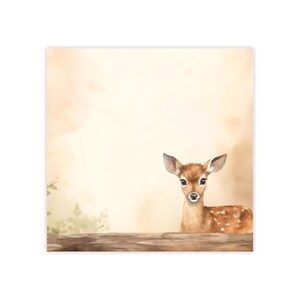 May include: A watercolor painting of a fawn with brown fur and white spots, looking directly at the viewer. The fawn is sitting on a log in a forest setting with a light brown background.