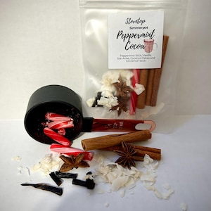 May include: A clear plastic bag filled with ingredients for peppermint cocoa. The ingredients include peppermint sticks, star anise, coconut flakes, and cinnamon sticks. The bag has a label that reads "Stovetop Simmerpot Peppermint Cocoa".