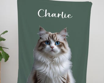 May include: A green wall tapestry featuring a fluffy cat with blue eyes. The cat's name, "Charlie," is written in white script at the top. The cat is the focal point of the tapestry.