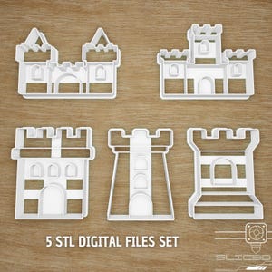 May include: Five white plastic castle-shaped cookie cutters. The cutters feature different castle designs, including turrets and arched doorways. The text "5 STL DIGITAL FILES SET" is visible at the bottom of the image.