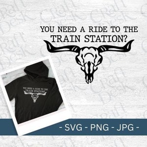May include: A black and white graphic design of a cow skull with horns and the text "You need a ride to the train station?"  The design is on a black hoodie.