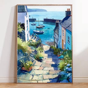 May include: Watercolor painting of a coastal village scene. A stone path leads down to a harbor with boats, surrounded by buildings in shades of blue and white. The artwork is framed in a light wood.