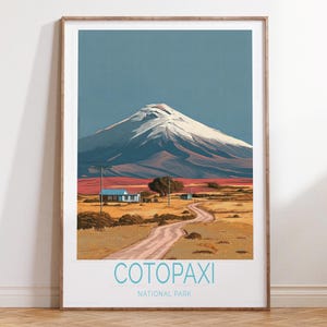 May include: A framed print of Cotopaxi National Park. The artwork depicts a snow-capped mountain under a blue sky, with a winding road leading to a small village. The text "Cotopaxi National Park" is displayed at the bottom.