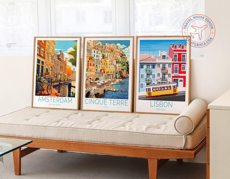 May include: Three framed travel posters with colourful illustrations of Amsterdam, Cinque Terre, and Lisbon. Each poster features the city name, country, and a small aeroplane icon.