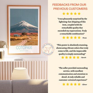 May include: A framed art print featuring a landscape of Cotopaxi National Park. The artwork depicts a snow-capped mountain, a road, and a small building under a blue sky. The print includes the text "COTOPAXI NATIONAL PARK".
