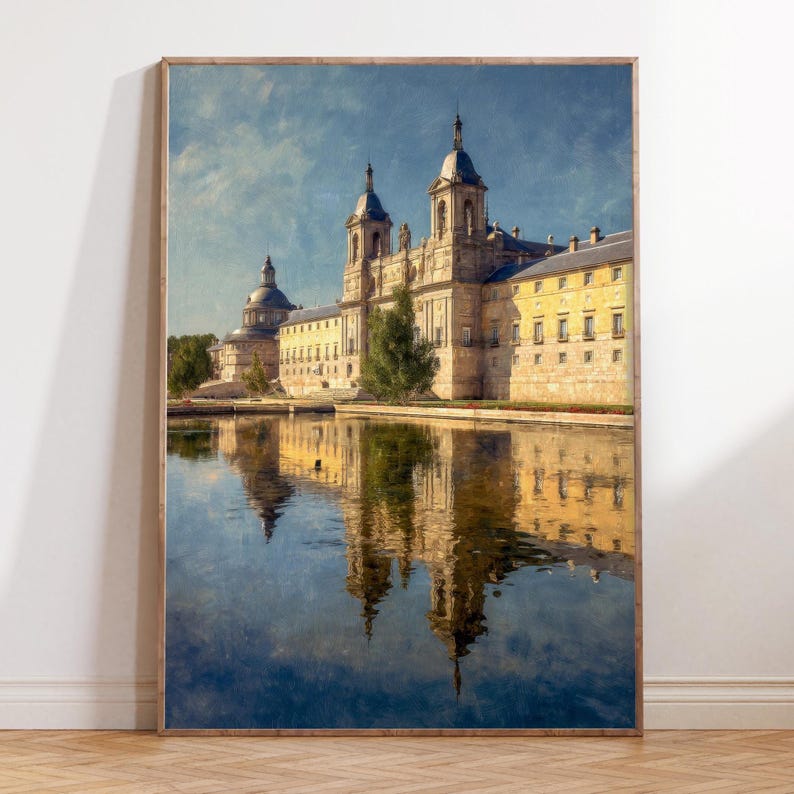May include: A framed print of a grand building complex reflected in a body of water. The architecture features multiple towers and domes, with a yellow and beige color palette. The sky is a mix of blue and white, and the water reflects the building's image.