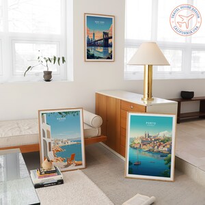 May include: Three framed travel posters with illustrations of New York City, Paros, Greece, and Porto, Portugal. The posters are hanging on a white wall in a modern living room.