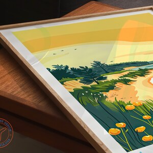 May include: A colorful illustration of a beach scene with a sandy shore, blue water, and green trees. The sky is a gradient of yellow and orange, suggesting a sunset. The image is framed in a light wood frame.