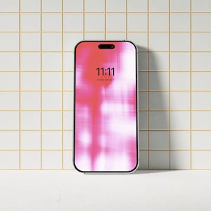 May include: A white smartphone with a pink and white abstract background on the screen. The time is 11:11.
