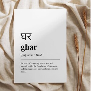 May include: A black and white printable art print with the Hindi word "घर" (pronounced "ghar") meaning "home" in English. The definition reads: "the heart of belonging, where love and warmth reside. the foundation of our roots and the place where cherished memories are made."