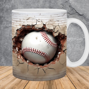 May include: White ceramic mug with a baseball breaking through a brick wall. The baseball is white with red stitching.
