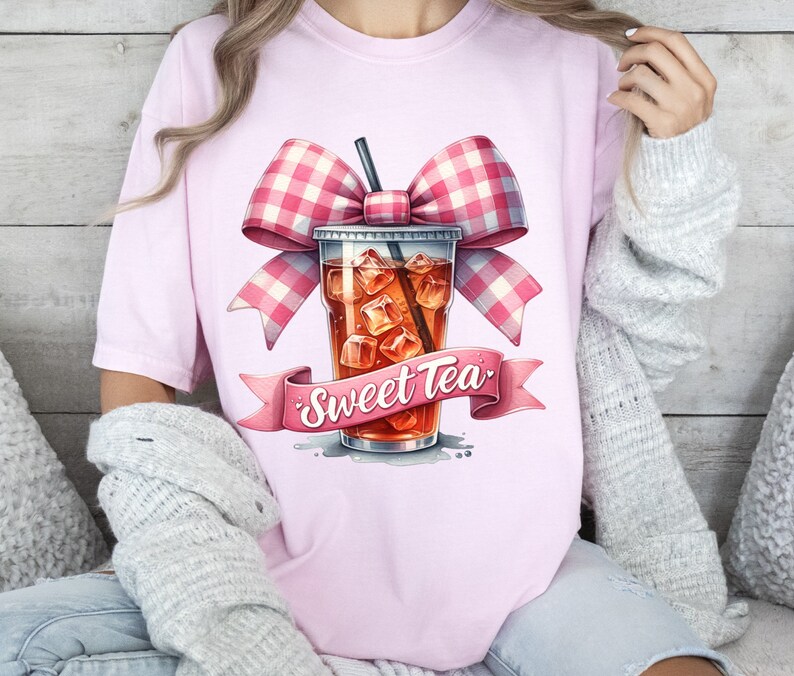 May include: Pink t-shirt with a graphic of a glass of iced tea with a pink and white gingham bow and the text "Sweet Tea".