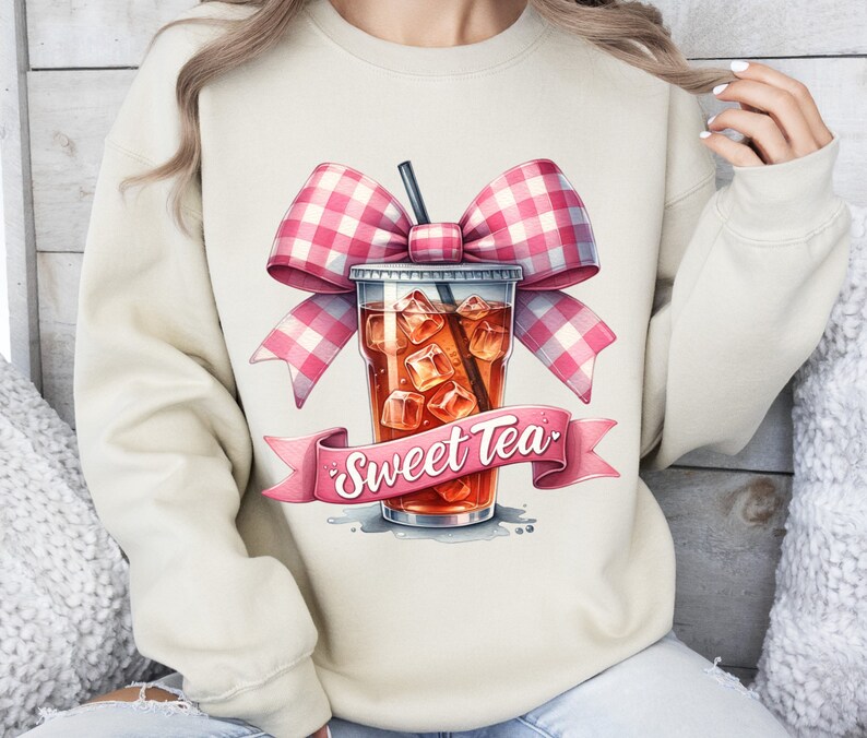 May include: A beige sweatshirt with a pink and white gingham bow on top of a glass of iced tea with the text "Sweet Tea" on a pink ribbon.