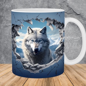 May include: A white wolf with blue eyes peeks through a broken wall, its head and shoulders visible. The wolf is set against a snowy mountain backdrop. The image is printed on a white ceramic mug.