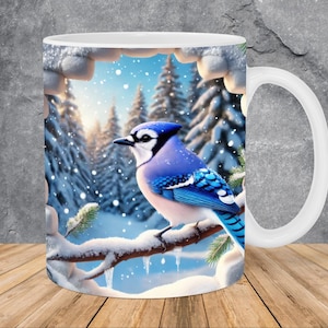 May include: White ceramic mug featuring a vibrant blue jay perched on a snow-covered branch. The background depicts a snowy forest scene with evergreen trees and falling snowflakes. The mug has a white handle.