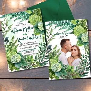 May include: Wedding invitation featuring the names "Wilson Miller and Rachel White" in elegant script. The invitation is adorned with watercolor greenery and floral accents. The date and time of the wedding are also included. A second invitation shows a couple kissing.