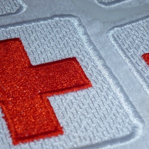 First Aid Red Cross embroidery file patch application various sizes and designs.