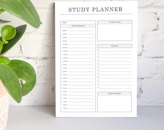 May include: A white study planner with the text "STUDY PLANNER" at the top. The planner includes sections for daily goals, to-do lists, and notes. It has a schedule from 6:00 AM to 8:00 PM.