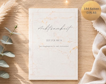 May include: A journal with a marble-like design and the word "Achtsamkeit" in script. The text "ZEIT FÜR MICH" and "Dein Wegbegleiter für mehr Achtsamkeit" are also visible. The journal has 144 pages and is DIN A5 size.