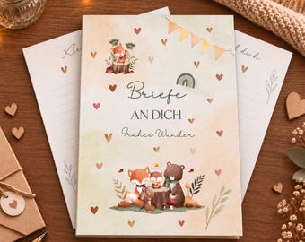 May include: A rectangular notebook with a cream-colored cover featuring watercolor illustrations of a fox, owl, and bear. The text reads "Briefe AN DICH Frühes Wunder" in dark gray script and print. Small hearts and bunting are scattered across the cover.