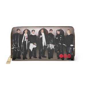 May include: A rectangular wallet with a gold zipper and a printed image of seven people. The image features a group of people in black outfits with white accents. The wallet has a brown background.