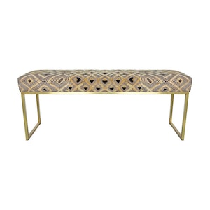May include: A rectangular bench with a patterned top and gold-colored metal legs. The bench top features a geometric design in black, tan, and cream colors. The legs are a simple, modern design.